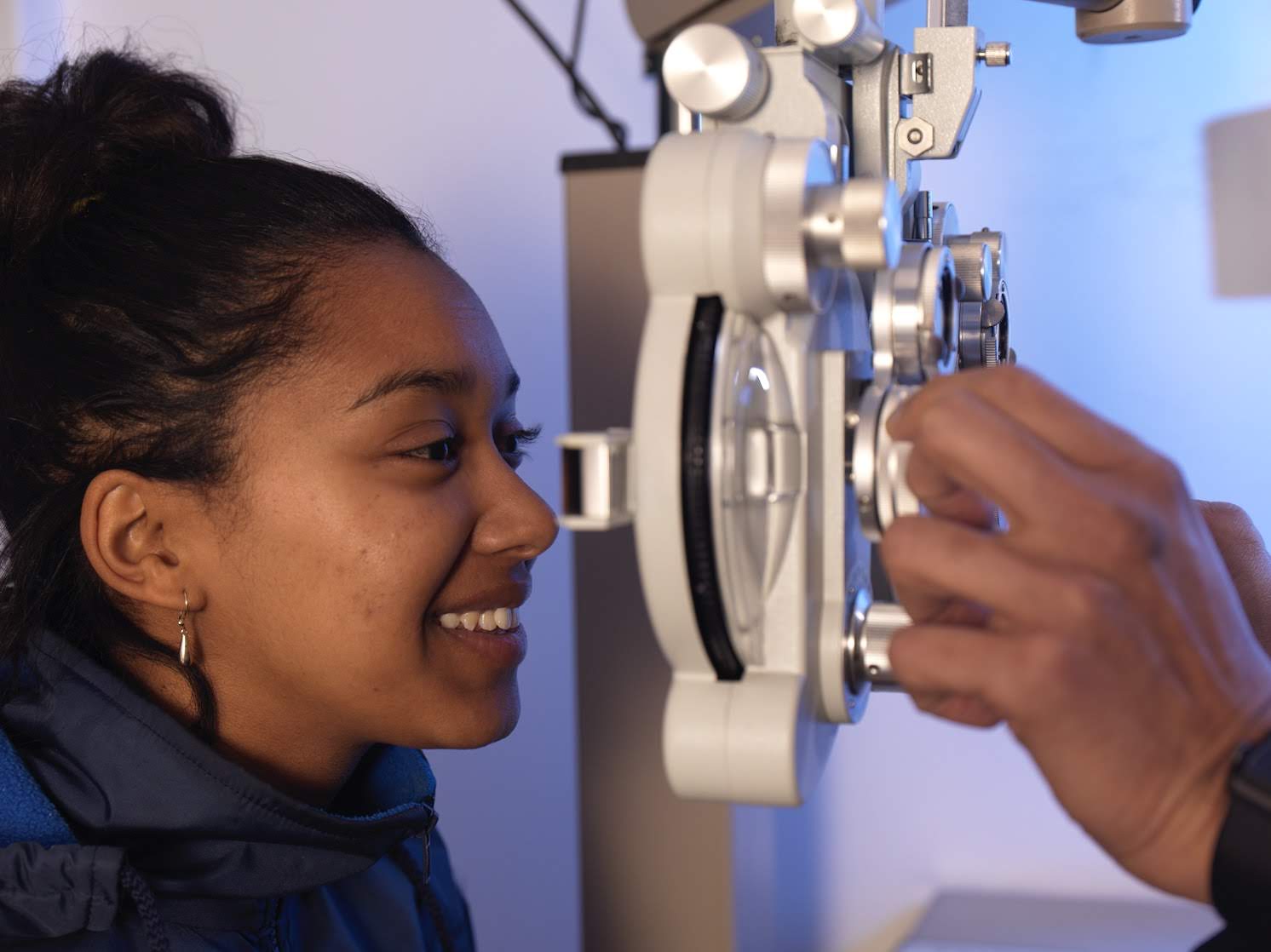 Optometrist carrying out an eye examination at a St John centre